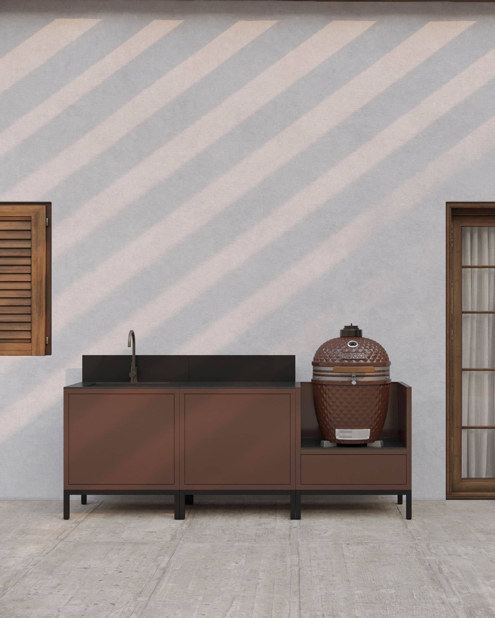 Outdoor-Küche auf Stelzen in Rostoptik mit integriertem Spülbecken, dunkler Arbeitsplatte, passender Rückwand und eigenem Kamado-Modul auf erhöhter Struktur.